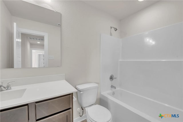 full bathroom featuring toilet, vanity, and shower / washtub combination