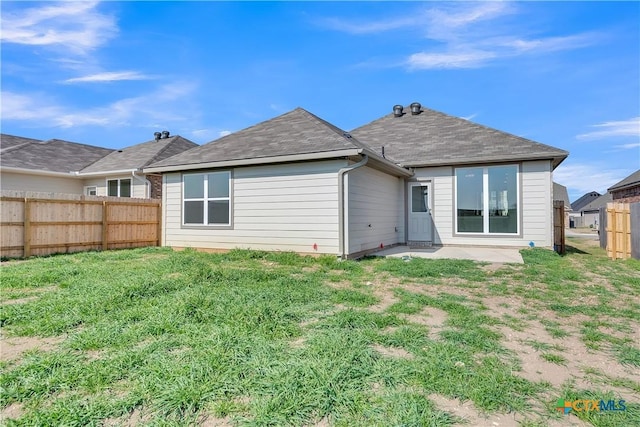 back of house with a patio and a yard