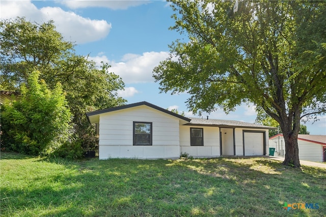 single story home featuring a garage and a front lawn