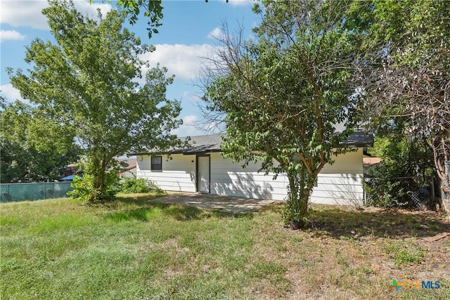 exterior space featuring a yard and fence