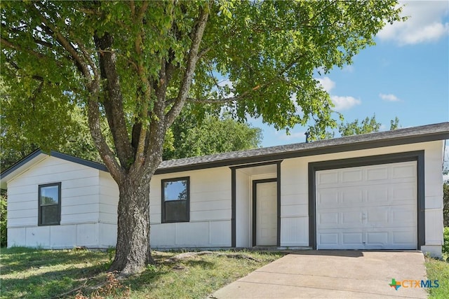 view of front of house featuring a garage and concrete driveway