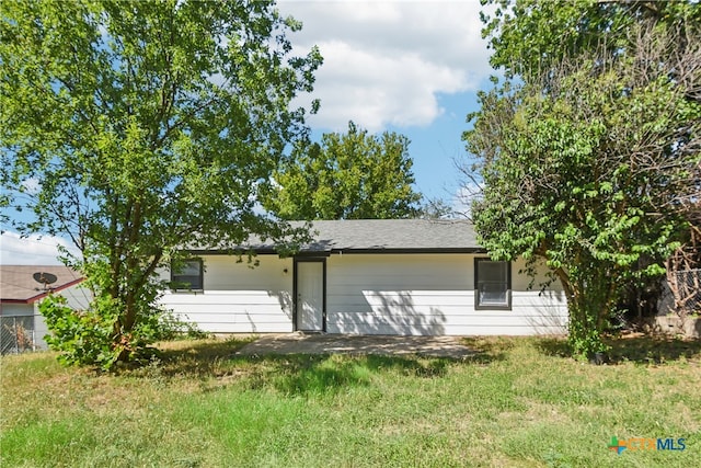 rear view of property with a yard