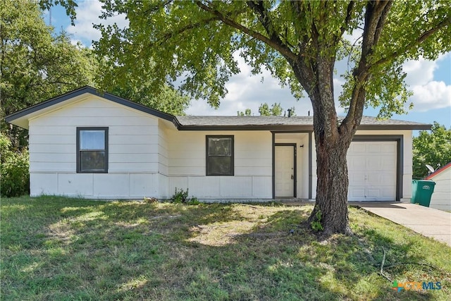 single story home with concrete driveway, a garage, and a front yard