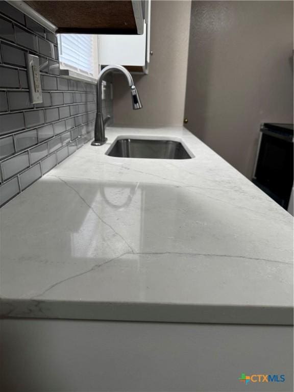 kitchen with a sink and backsplash