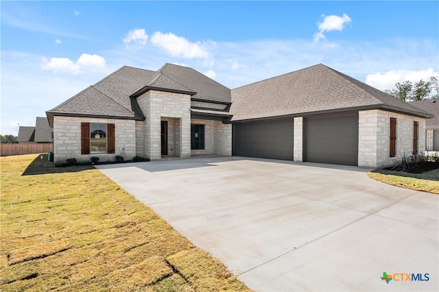 view of front facade with a front yard and a garage