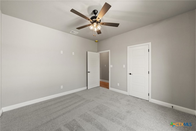 unfurnished bedroom with ceiling fan and light colored carpet