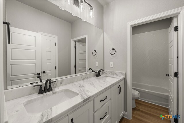 bathroom featuring hardwood / wood-style floors, vanity, and toilet