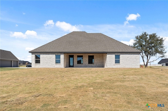 rear view of house with a lawn