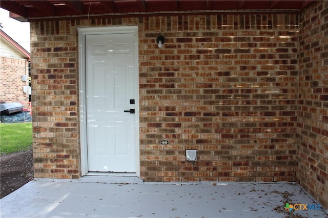 entrance to property with brick siding