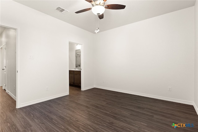 interior space with dark wood finished floors, visible vents, ceiling fan, and baseboards