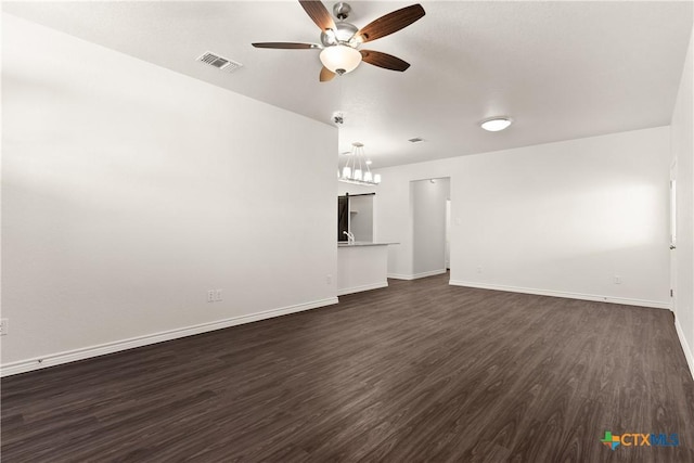 unfurnished living room featuring visible vents, baseboards, ceiling fan, and dark wood-style flooring