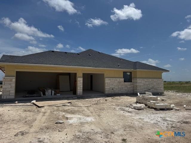 490 County Road 56, Copperas Cove, TX 76522 - back of property with stone siding, a shingled roof, and a garage