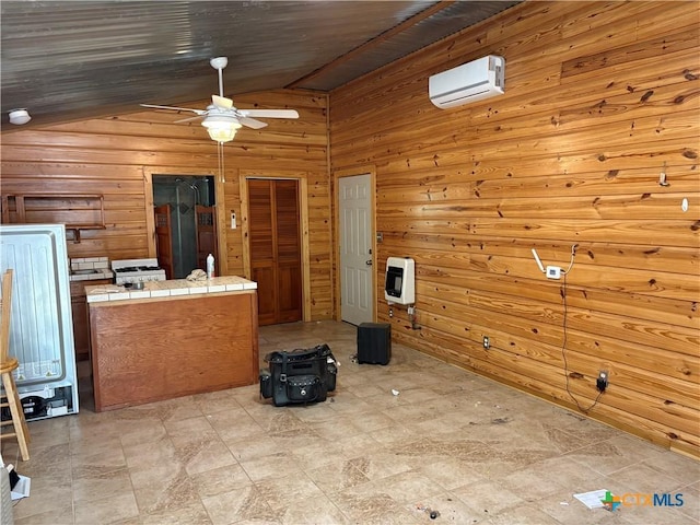 904 Deer Springs Dr, Burnet, TX 78611 - unfurnished living room with a wall mounted air conditioner, heating unit, a ceiling fan, lofted ceiling, and wooden walls