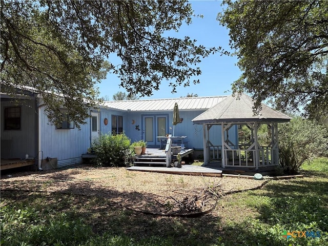 904 Deer Springs Dr, Burnet, TX 78611 - back of property featuring a gazebo, metal roof, and a wooden deck