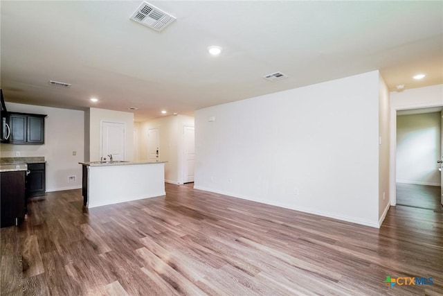 613 S 24th St, Temple, TX 76501 - unfurnished living room with baseboards, dark wood-style floors, and visible vents