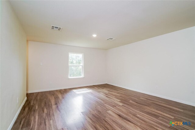 613 S 24th St, Temple, TX 76501 - empty room featuring visible vents, wood finished floors, and baseboards