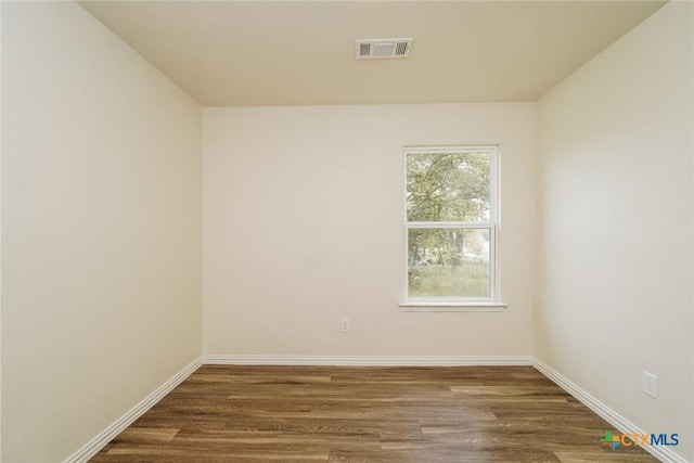 613 S 24th St, Temple, TX 76501 - empty room featuring baseboards, visible vents, and dark wood finished floors