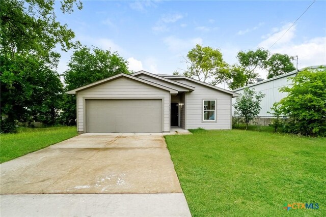 613 S 24th St, Temple, TX 76501 - view of front of property featuring an attached garage, driveway, and a front lawn