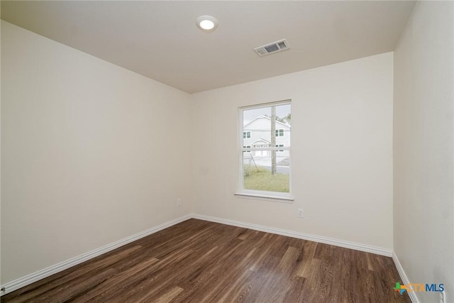613 S 24th St, Temple, TX 76501 - empty room featuring visible vents, baseboards, and dark wood-style floors