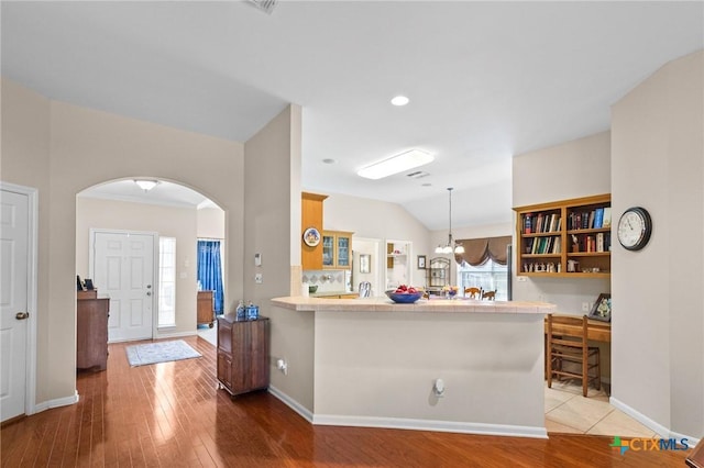 301 Deerchase, Victoria, TX 77901 - entryway with arched walkways, light wood-style floors, baseboards, lofted ceiling, and a chandelier