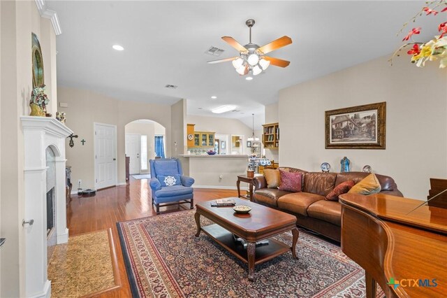 301 Deerchase, Victoria, TX 77901 - living area featuring ceiling fan, wood finished floors, arched walkways, a fireplace, and baseboards