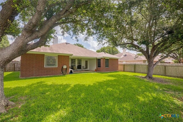 301 Deerchase, Victoria, TX 77901 - back of property with brick siding and a chimney