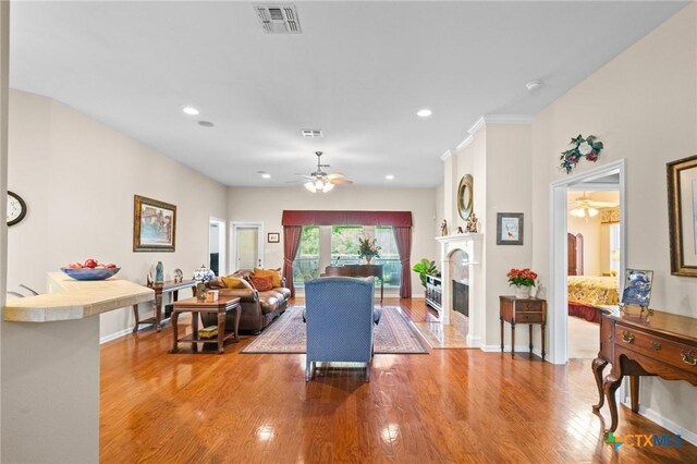 301 Deerchase, Victoria, TX 77901 - living area featuring a ceiling fan, wood finished floors, a fireplace, and recessed lighting