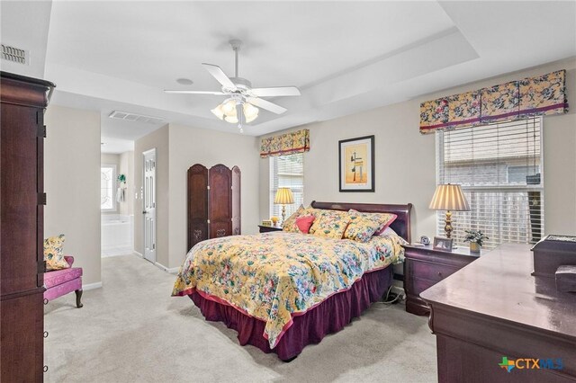 301 Deerchase, Victoria, TX 77901 - bedroom featuring light carpet, multiple windows, baseboards, and a raised ceiling