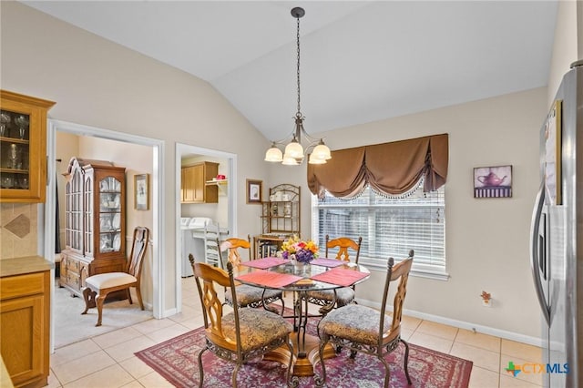 301 Deerchase, Victoria, TX 77901 - dining room with a chandelier, vaulted ceiling, light tile patterned flooring, baseboards, and washer / dryer