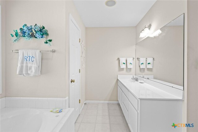 301 Deerchase, Victoria, TX 77901 - full bathroom with vanity, a garden tub, baseboards, and tile patterned flooring