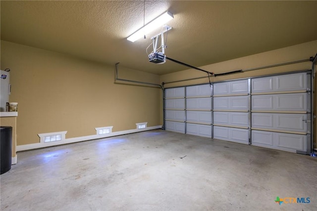 garage with baseboards and a garage door opener