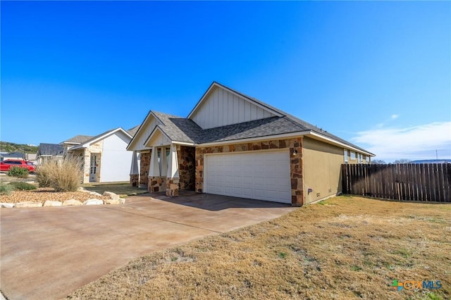 single story home featuring a garage, driveway, stone siding, roof with shingles, and fence