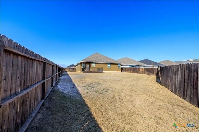 view of yard with a fenced backyard