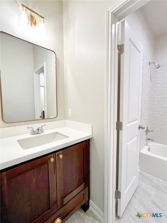 bathroom with vanity and tiled shower / bath combo