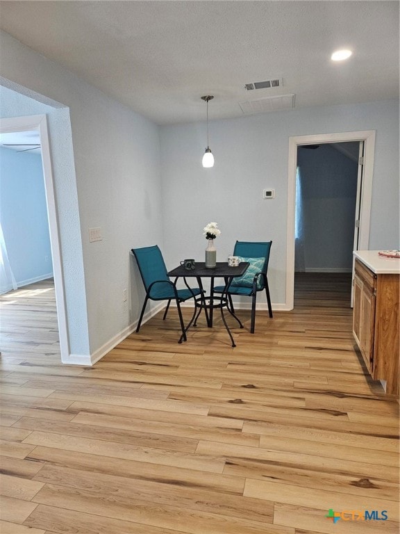 dining space featuring light wood-type flooring