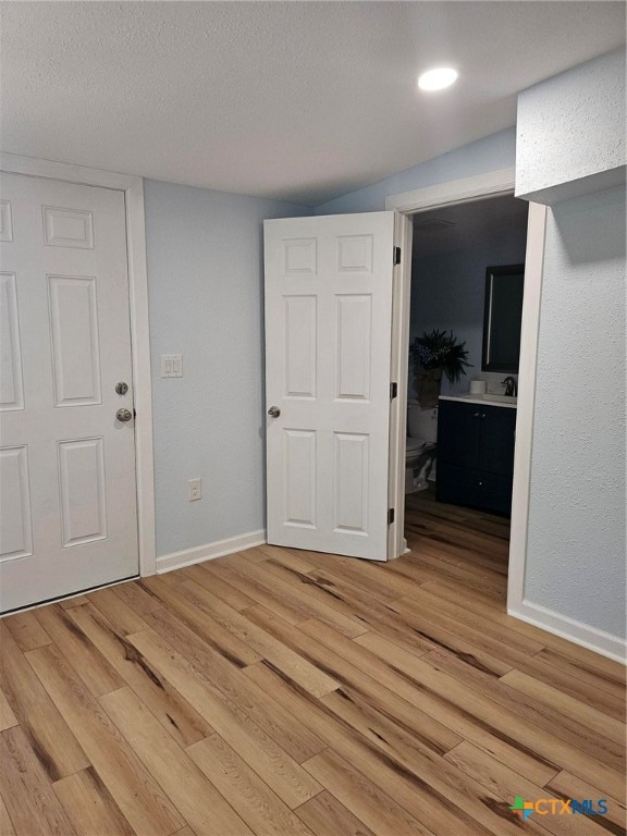 interior space featuring hardwood / wood-style floors and a textured ceiling