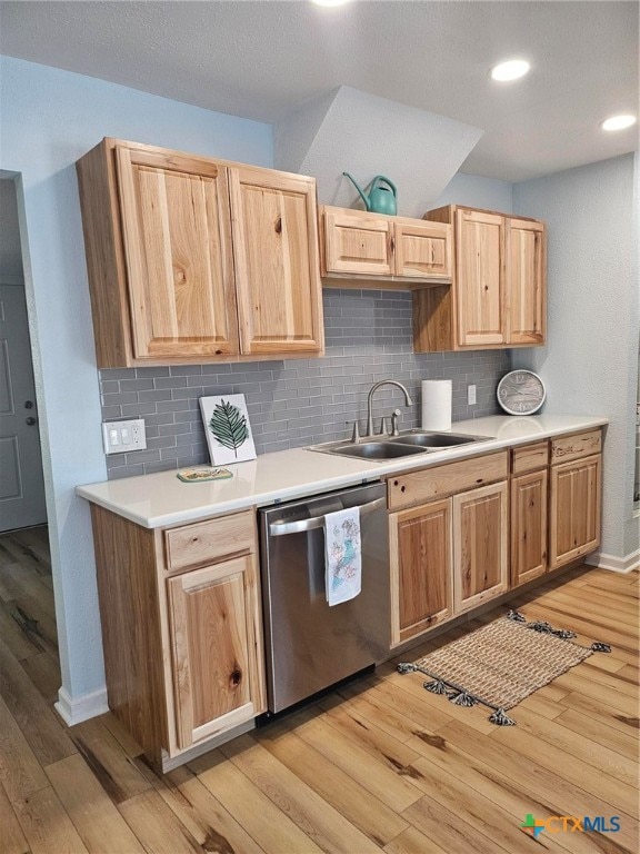 kitchen with light hardwood / wood-style floors, sink, dishwasher, and tasteful backsplash