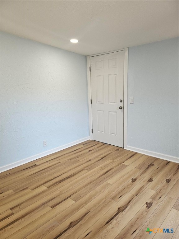 unfurnished room with light hardwood / wood-style floors