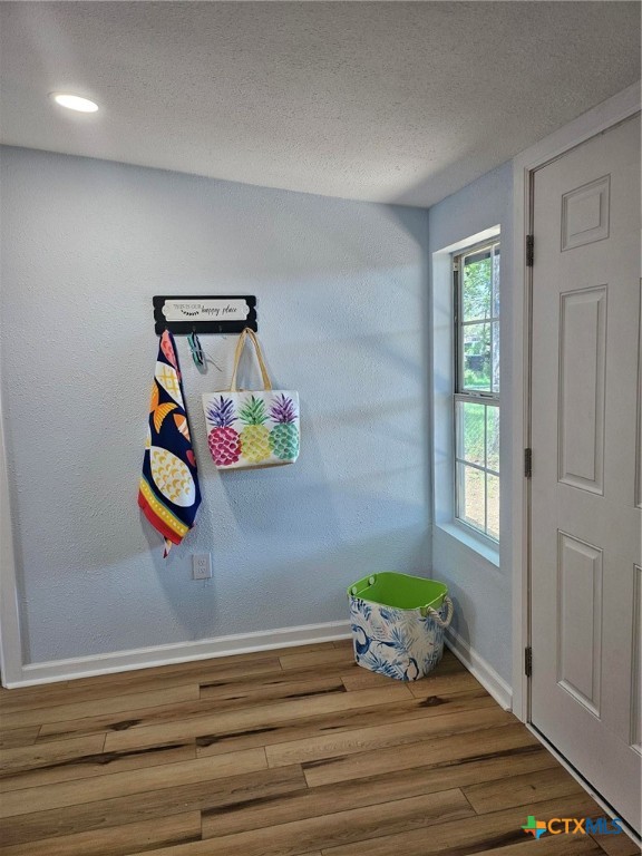 doorway to outside featuring hardwood / wood-style floors and a textured ceiling