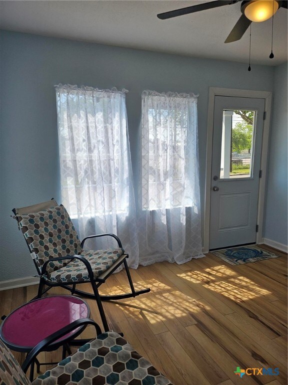 interior space featuring hardwood / wood-style floors and ceiling fan