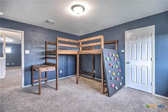 bedroom featuring carpet and a textured ceiling