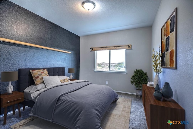 bedroom with carpet floors and a textured ceiling