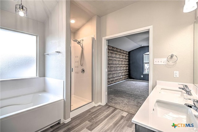 bathroom featuring wood-type flooring, a healthy amount of sunlight, and plus walk in shower