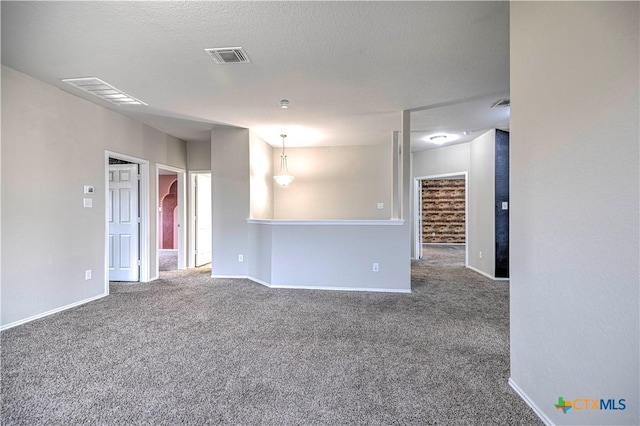 carpeted spare room with a textured ceiling