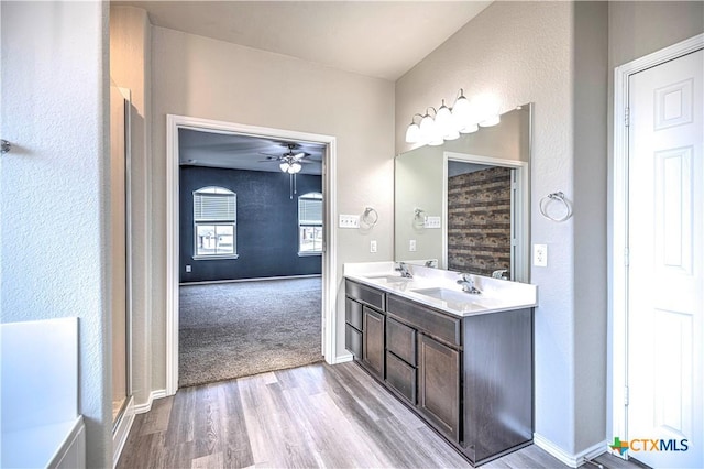 bathroom featuring hardwood / wood-style flooring, vanity, and ceiling fan