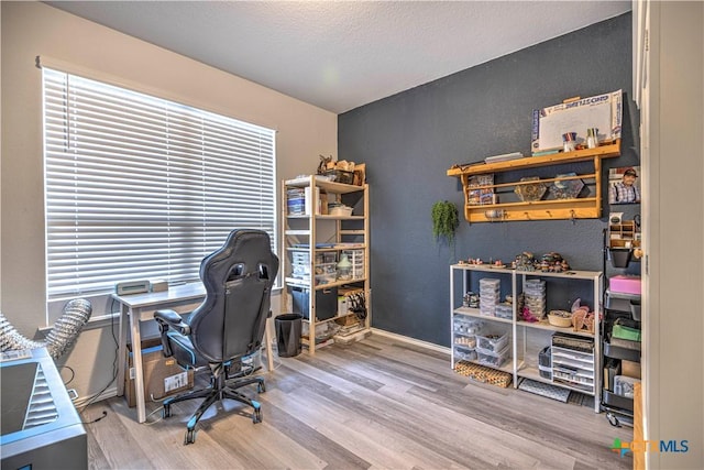 office with hardwood / wood-style flooring and a textured ceiling