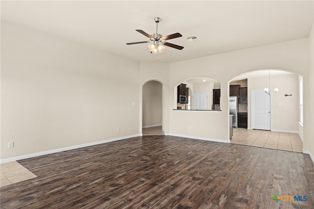 3411 Aubree Katherine Dr, Killeen, TX 76542 - unfurnished living room with wood finished floors, a ceiling fan, and arched walkways