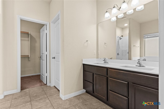 3411 Aubree Katherine Dr, Killeen, TX 76542 - bathroom with double vanity, a walk in closet, tile patterned floors, and a shower