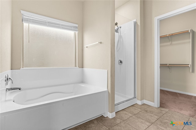 3411 Aubree Katherine Dr, Killeen, TX 76542 - full bathroom featuring a shower stall, a bath, tile patterned flooring, and a walk in closet