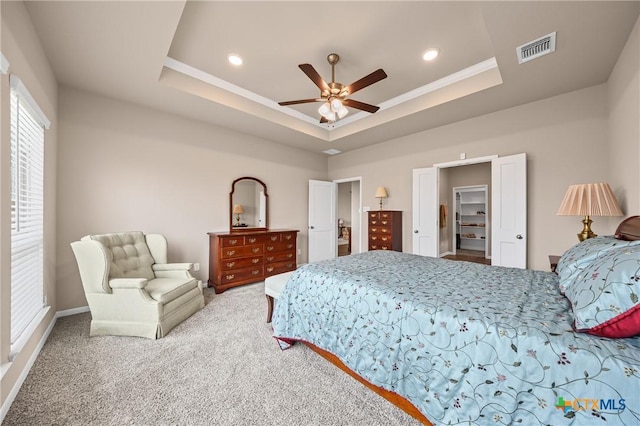 7109 Hammermill Ln, Temple, TX 76502 - carpeted bedroom with a tray ceiling, crown molding, recessed lighting, ceiling fan, and a spacious closet
